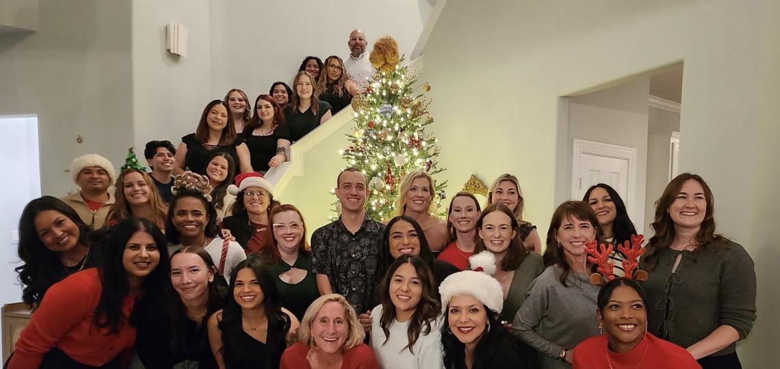 large group of people smiling at a holiday event