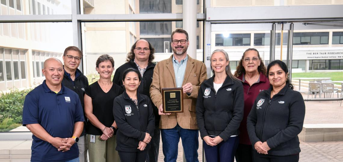 group of people holding an award