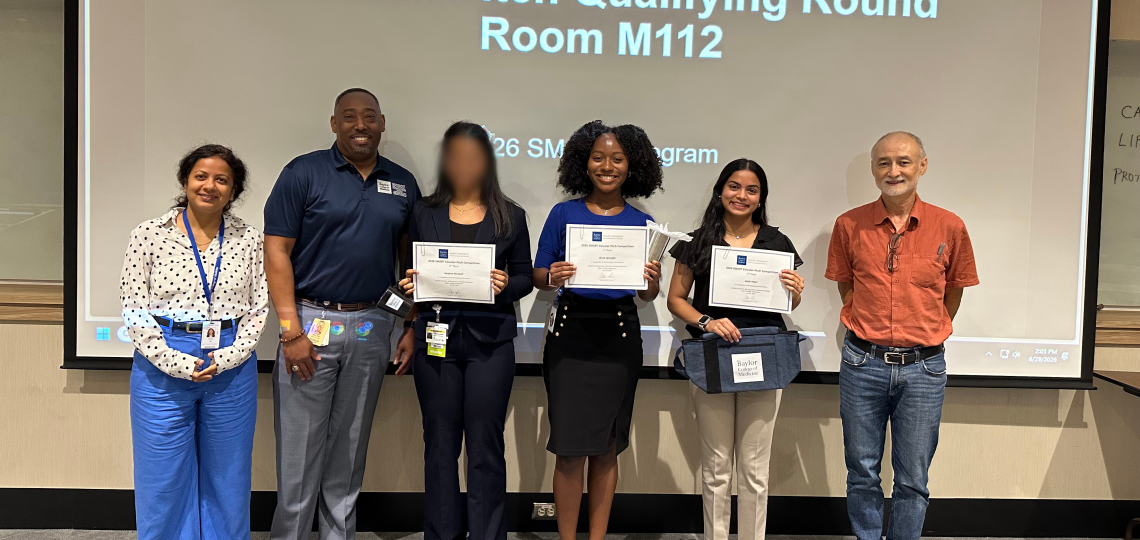 Students and teachers smiling in front of signage reading "Elevator Pitch Qualifying Round."