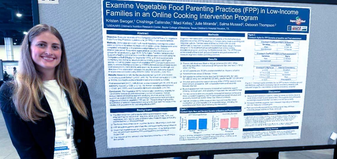 Kristen Swoger standing by scientific poster