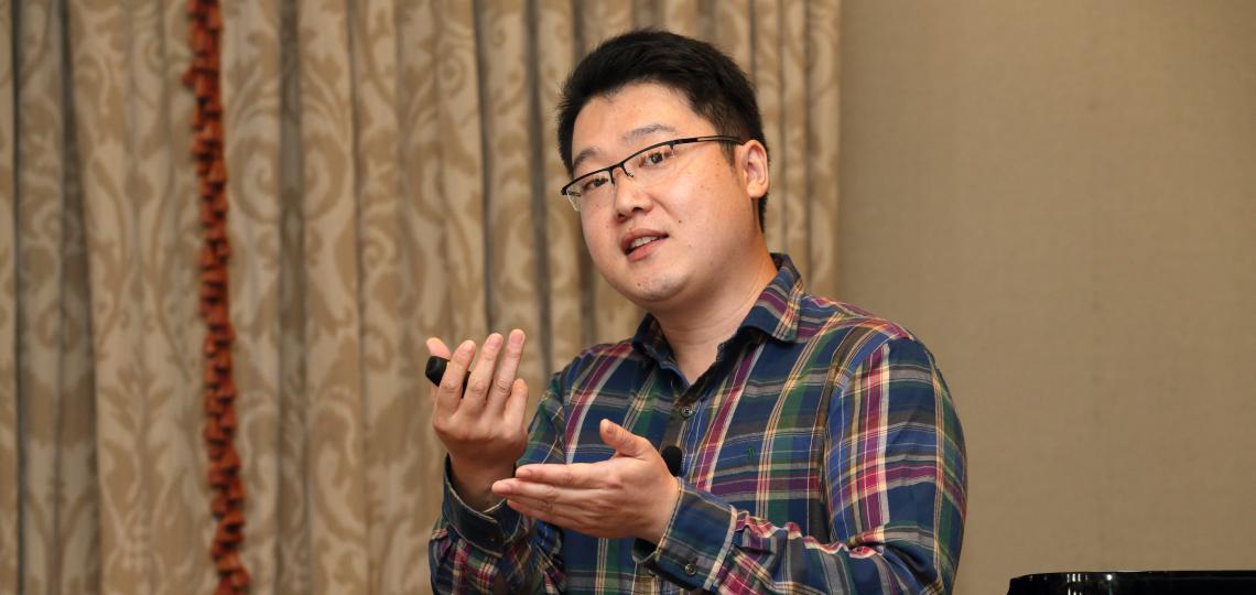 Dr Fangrui Wu makes a point at the annual department research conference.