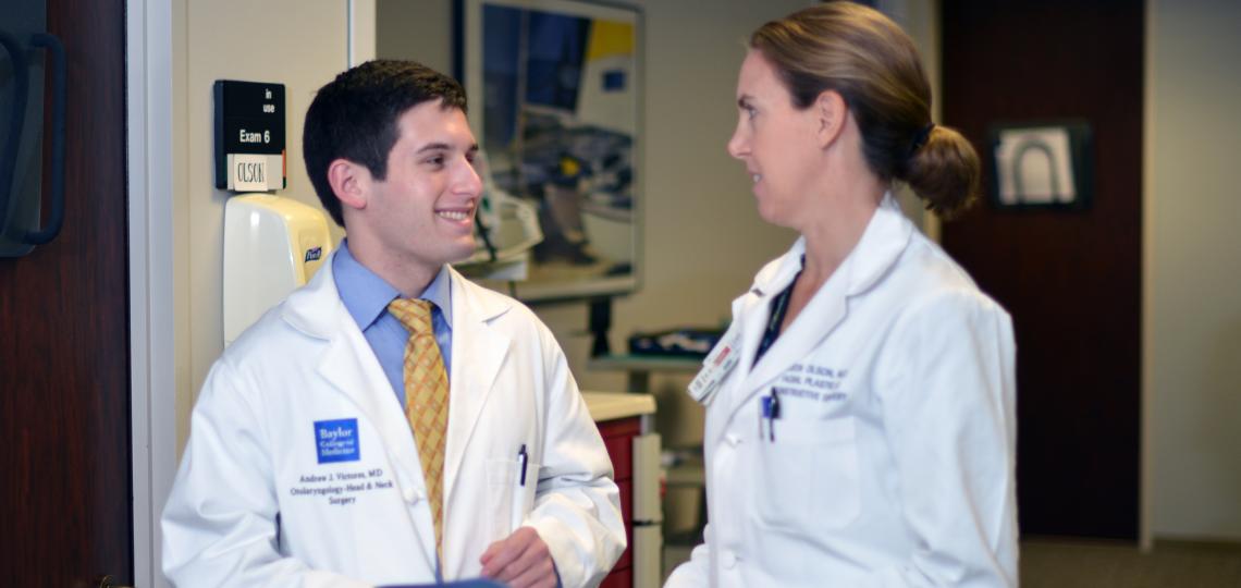 Dr. Krista Olson talks with resident Dr. Andrew Victores in clinic.