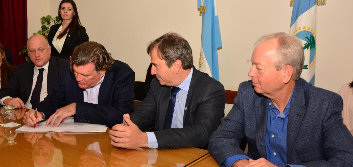 Mike Mizwa, CEO of BIPAI, seated second from left, signs a memorandum of agreement to launch a maternal and child health program in Argentina.