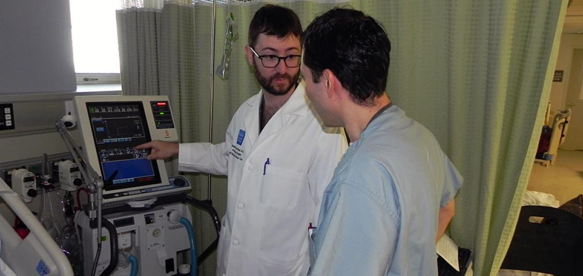 Dr. Jeremy Ward offers hands-on training to surgical critical care residents.