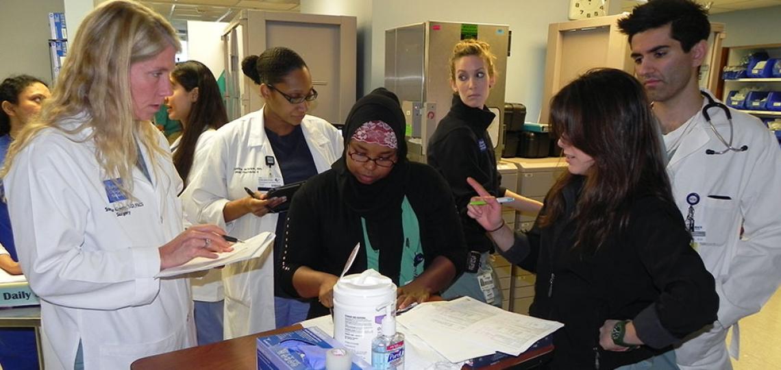 Dr. Stephanie Gordy engages surgical critical care residents during rounds.