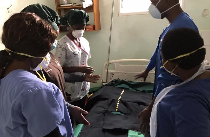 Global Women's Health Track residents attending a patient in the Malawi clinic.