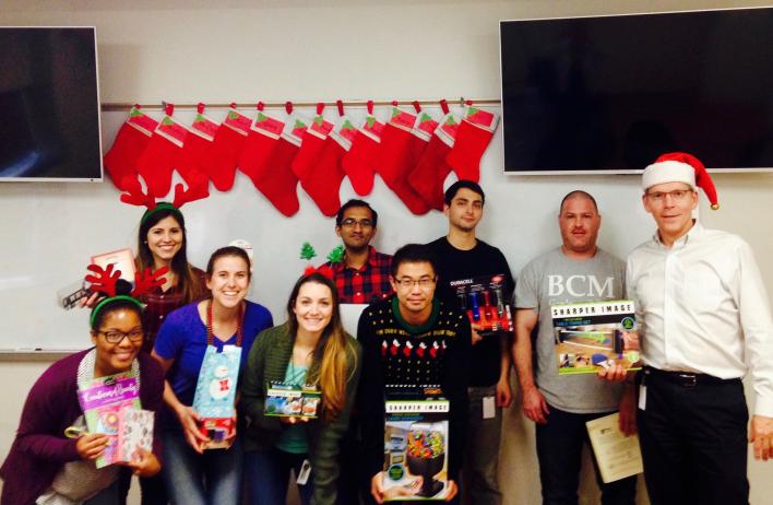 2016 Holiday White Elephant Party: showing off gifts (some stolen more than once).