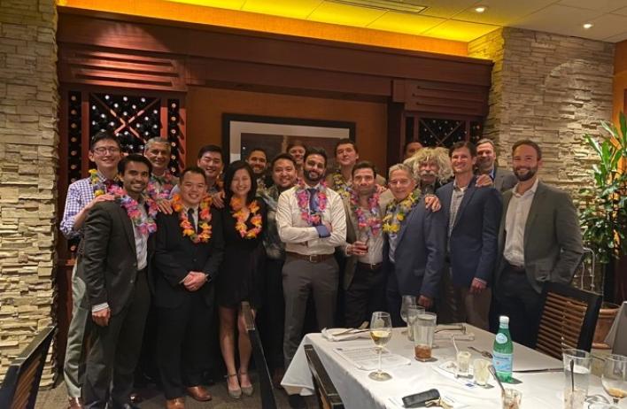 Recent R4 graduates at their residency graduation, wearing leis gifted by their coresident Brian Imada.