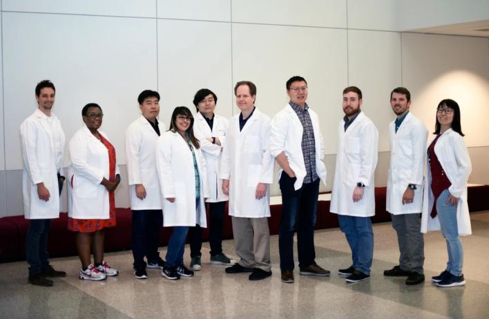 Research team suited up in lab coats.