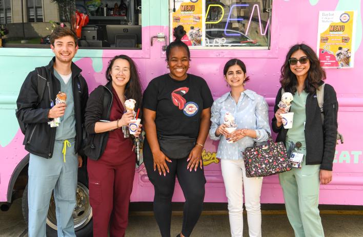 Second-year medical students enjoy an ice cream social near the Alkek Fountain in front of Baylor's Cullen building.