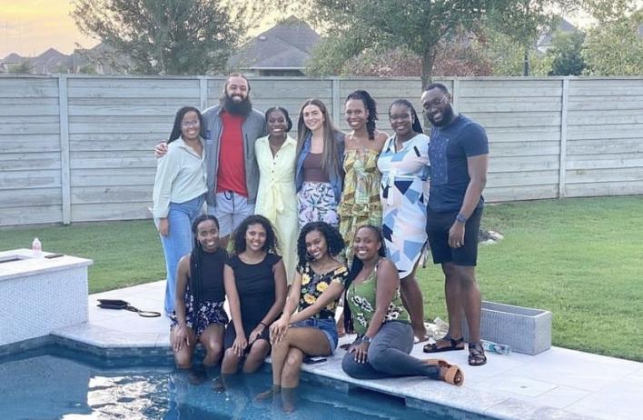 A large group of internal medicine residents pose in front of an outdoor pool