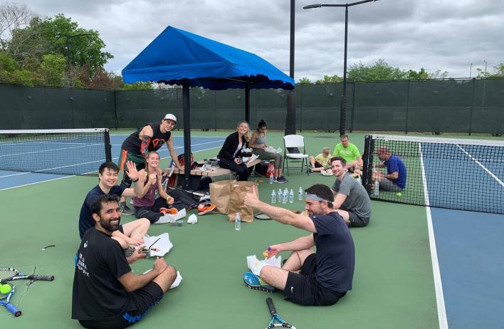 Residents snacking on a tennis court