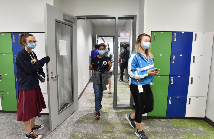 Students walking into a social space