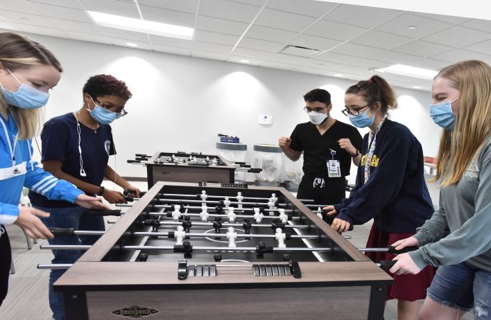 Students playing Foosball