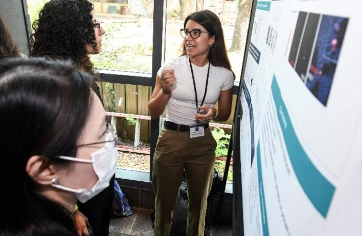 People at the Research Retreat at the Houston Zoo studying poster presentations
