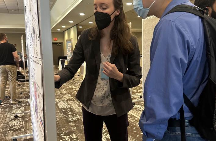 Katie Pendleton presents a poster to conference attendees.