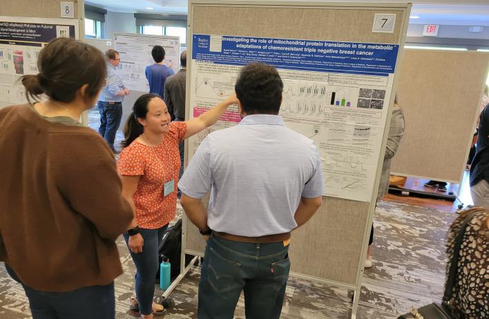 Mariah Berner presents a poster to conference attendees.