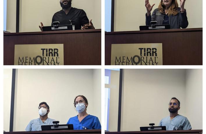 Five speakers standing behind podiums while speaking