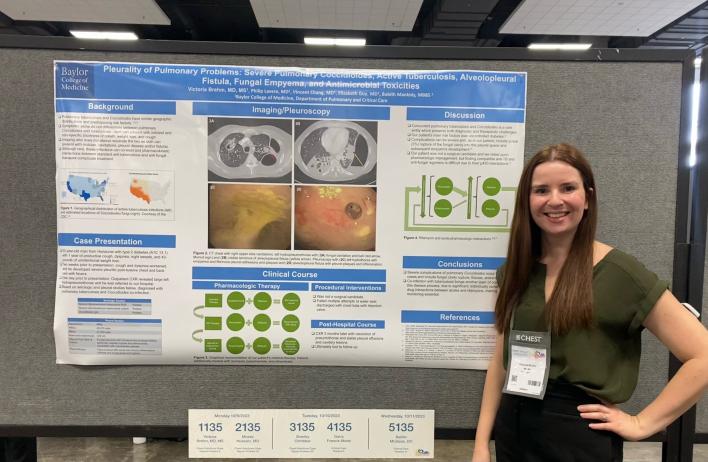 A person standing in front of their research poster