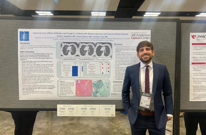 A person standing in front of their research poster