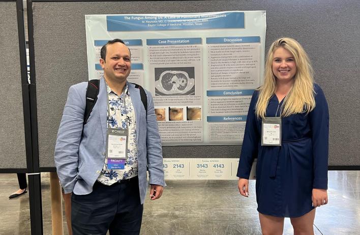 A person standing in front of their research poster