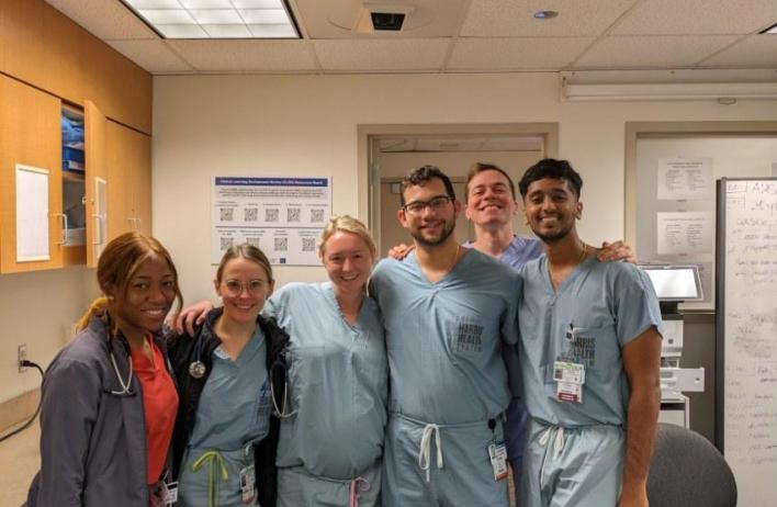 Several residents smiling in scrubs