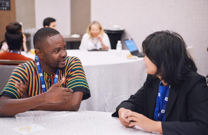 Scholars having conversation at the Summit