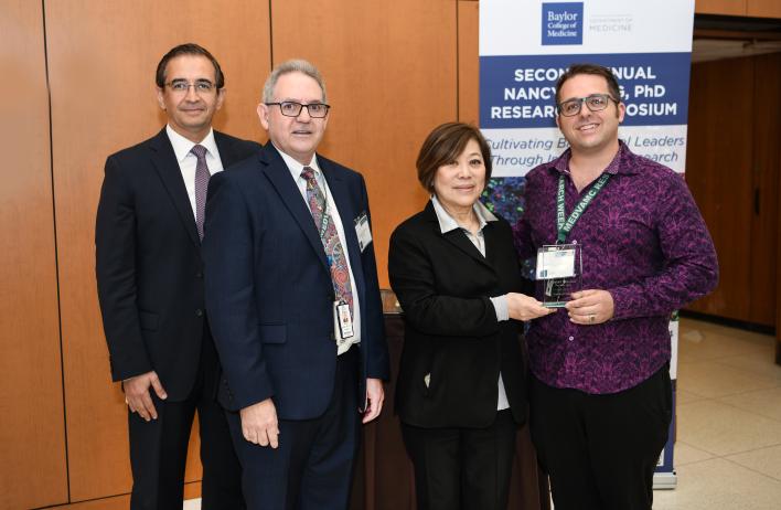 Caption: CTRID T32 trainee Dr. Justin Courson winning second place in the Second Annual Nancy Chang, PhD Research Symposium poster session, presented to him by Dr. Hashem El-Serag, Dr. Rolando Rumbaut, and Dr. Nancy Chang (left to right).