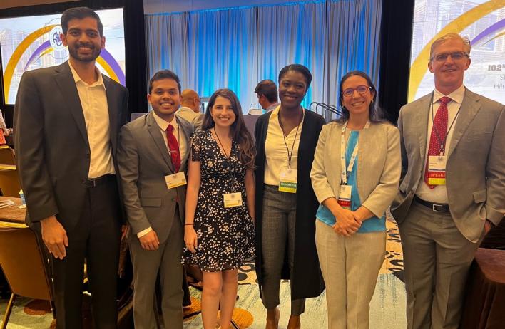 small group of people standing together smiling at a nice event
