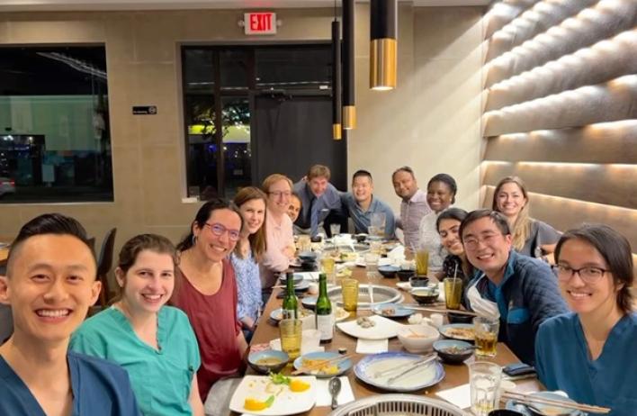 group of people smiling at a dinner event