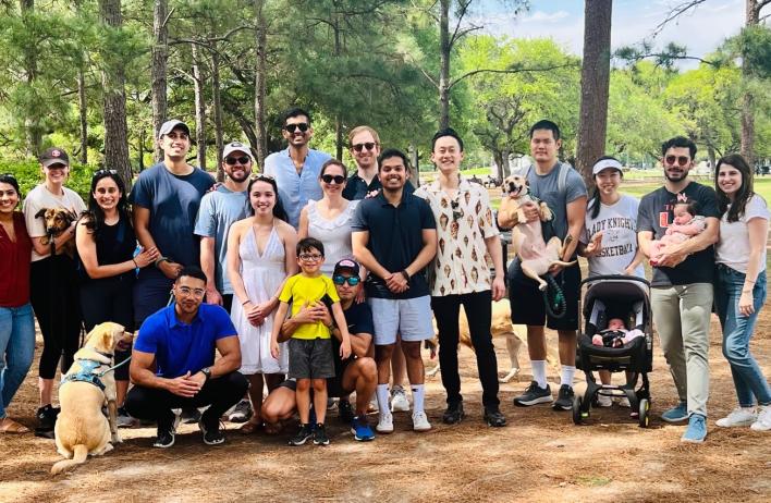 large group of people smiling outside