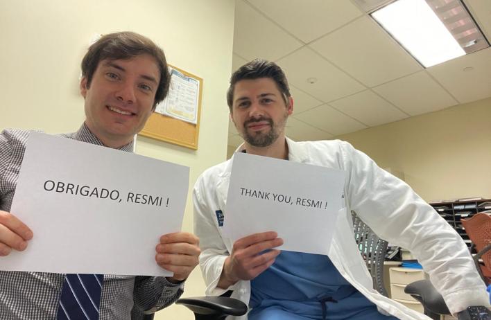 two residents holding thank you signs