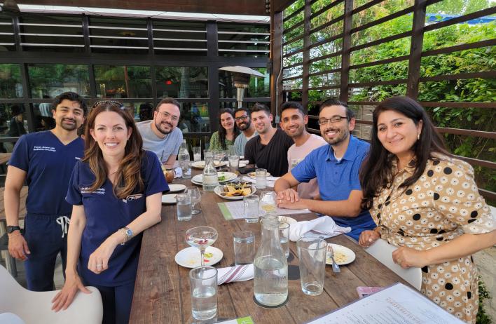 group of people smiling at dinner