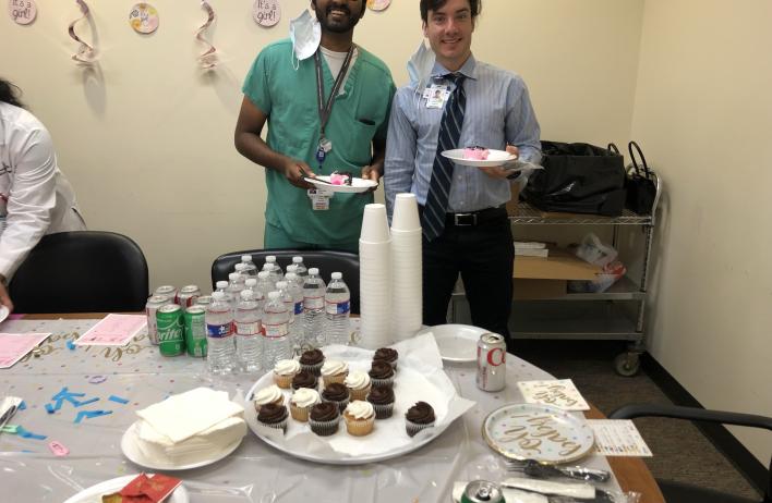 two people smiling and enjoying cupcakes