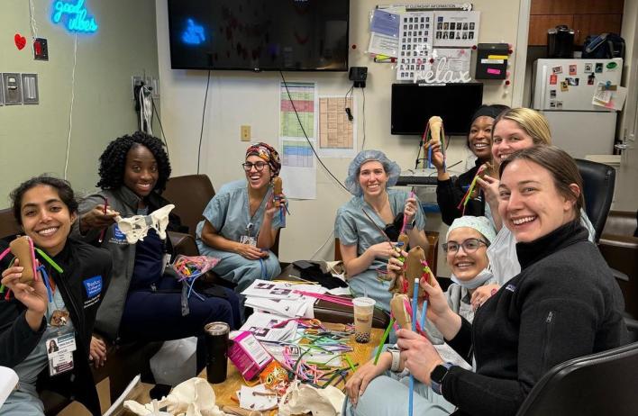 OB/GYN residents building things together at a table