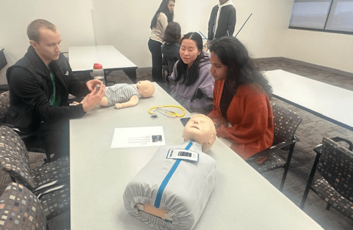 Students inspect the upper torso of a test dummy