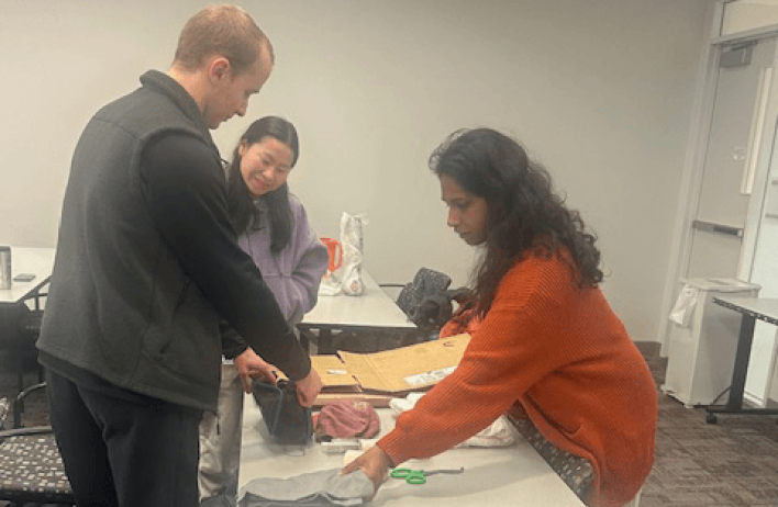Students rummaging through the assortment of items