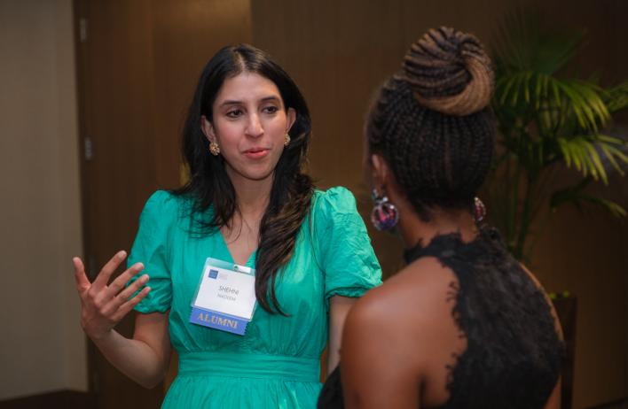 A happy alumnus speaking to another partygoer