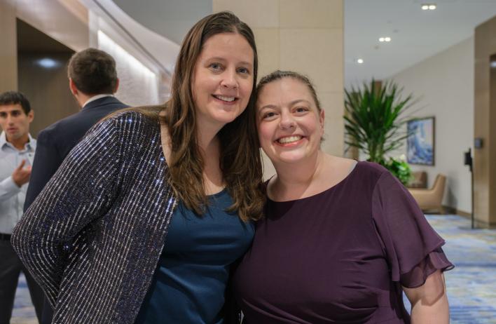 Two people smiling for the camera, shoulder to shoulder