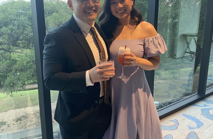 two people dressed nicely smiling