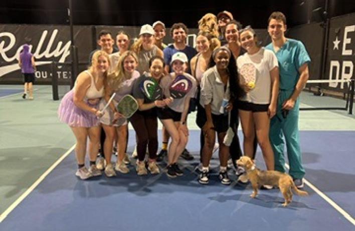 The residents snap a group photo after their pickleball game.