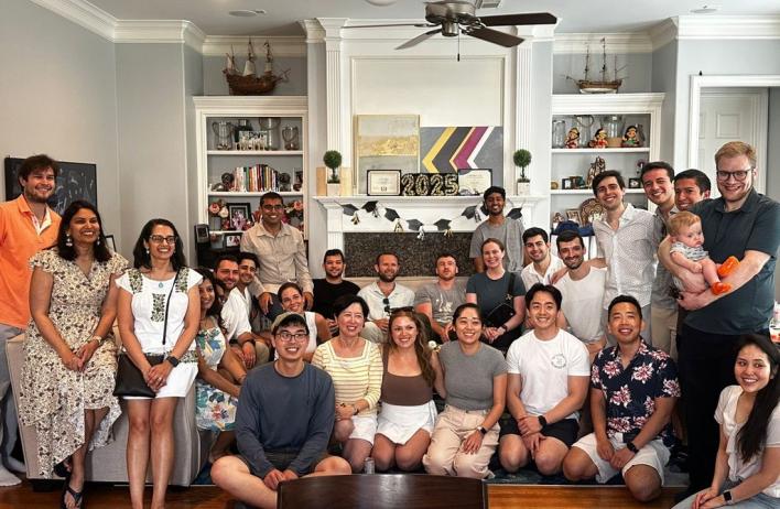 a large group of people in a living room smiling