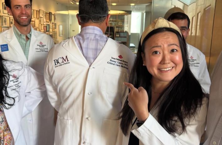 a woman smiling and pointing at a man acting goofy