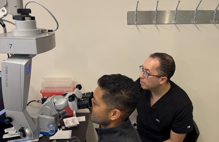 Two people using a device to facilitate simulation.