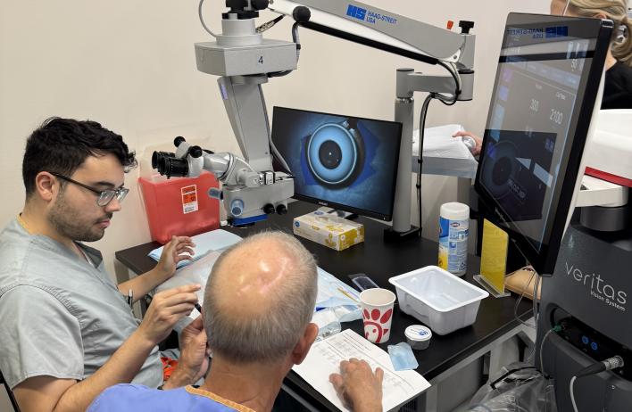 Two people talking while going over materials in a lab.