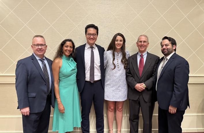 6 people standing together, smiling