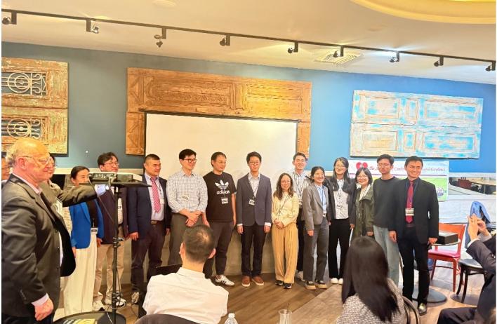 members of the lab smiling in a conference room