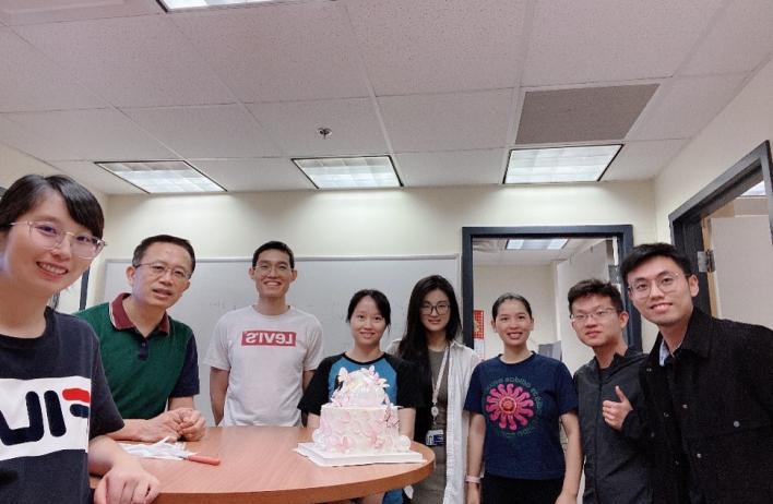 lab members smiling together, celebrating a birthday