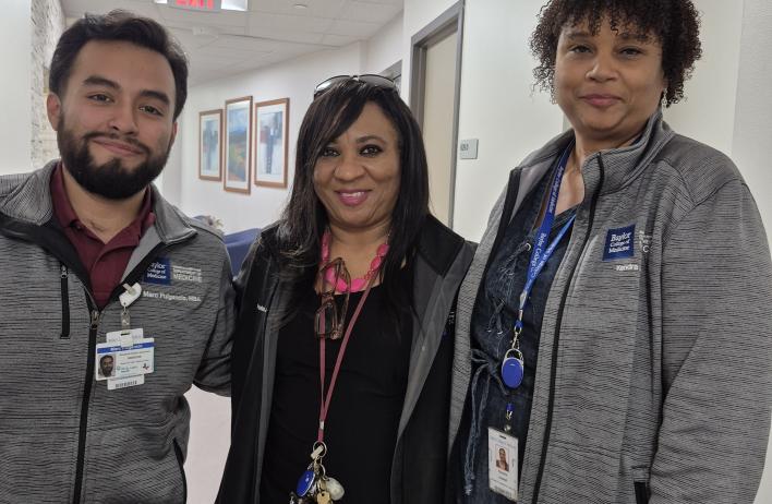 3 people standing together, smiling