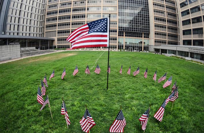 A singular American flag is surrounded by 25 smaller ones, to commemorate the 25th anniversary of September 11.